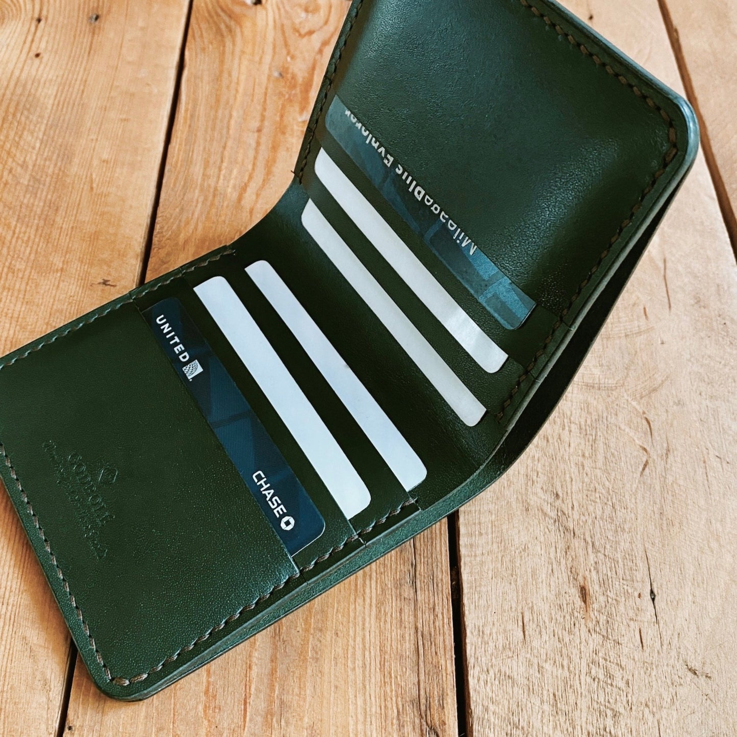 This is a slim wallet made with full grain leather and is hand stitched with saddle stitching.